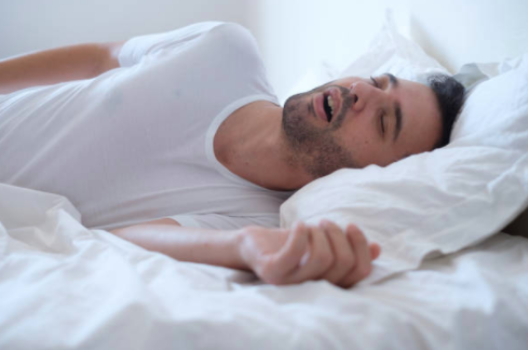 Man sleeping in bed and snoring