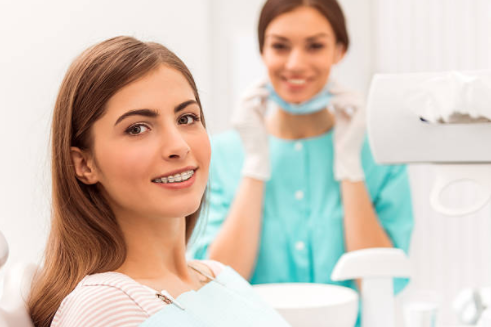Girl with braces at her orthodontic appointment