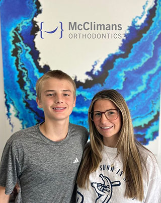 Kids standing in front of McClimans Ortho sign